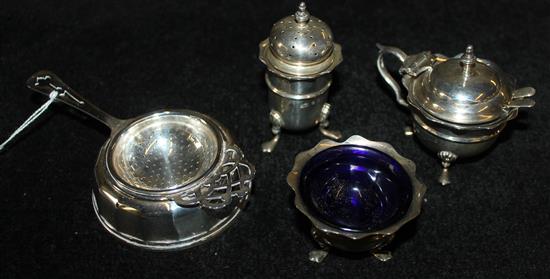 Silver tea strainer and stand & a three-piece silver condiment set with 2 spoons